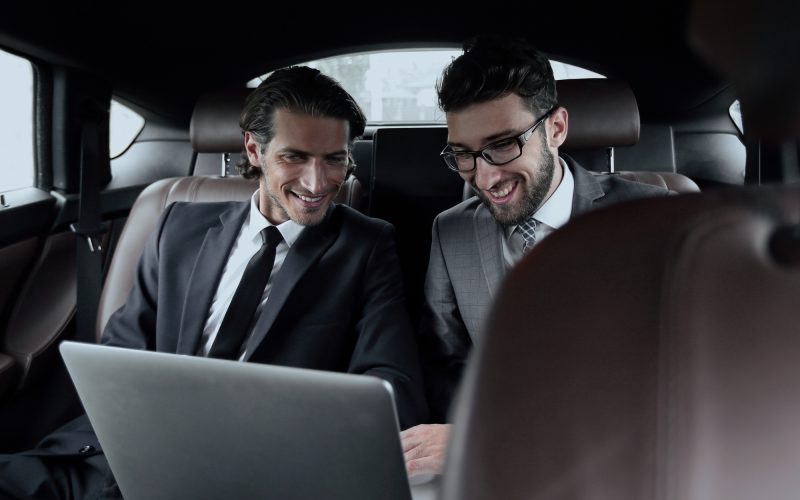 business partners talking,sitting in the car